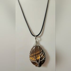 Tree of Life pendant with a tiger's eye gemstone.